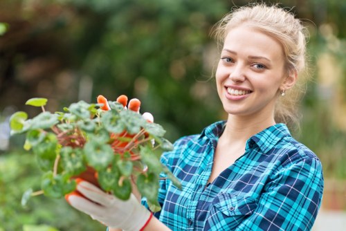 Front view of a Sydenham garden with professional gardener starting work